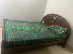 Used wooden bed without mattress