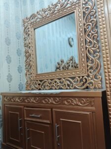 Golden luxury dressing table with cabin and drawers.